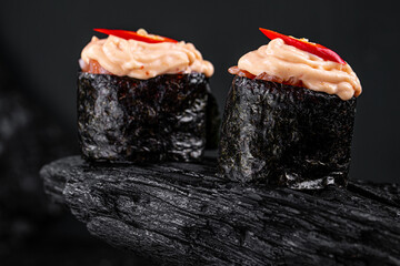 Canvas Print - spicy eel sushi on black background