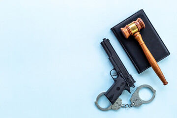 Crime concept. Hand gun weapon with handcuffs