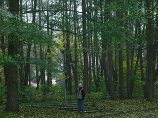 a woman is walking in the forest 2