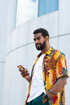 Afro-American man with a smartphone in the street 