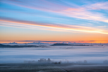 Wall Mural - Fantastic sunrise over the landscape with wind turbines in the background