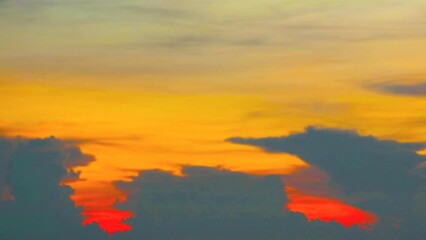 Wall Mural - blur sunset red yellow orange cloud on the sky over sea time lapse