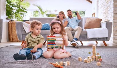 Sticker - Development, family and children with math toys and playing with building blocks in the house living room. Education, mother and relaxed father watching tv with kids or siblings learning from a game