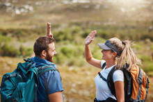 High five, success and couple hiking in nature with motivation, goal and support in Puerto Rico. Teamwork, celebration and man and woman excited about travel adventure on a mountain for holiday