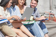 © yurolaitsalbert - group of students with a laptop sitting on the steps.