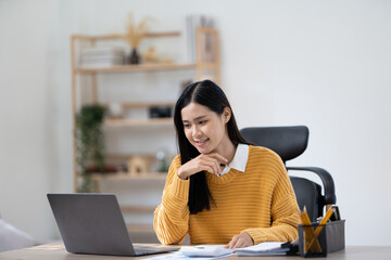 Happiness Attractive Asian woman in yellow shirt working with computer laptop thinking to get ideas and requirement in Business startup at modern office or Co-working space,Business Startup Concept