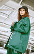 © C D/peopleimages.com - Fashion, low angle portrait and woman in city or street with trendy, stylish and cool clothing. Gen z, freedom and creative female model from South Africa in designer brand hat, jacket and outfit.