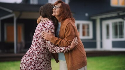 Wall Mural - Portrait of a Happy Young Pregnant Female Standing Together with Her Senior Mother or Grandparent. Family Members Hug, Smile, Pose for Camera. Standing Outside on a Warm Summer Day.