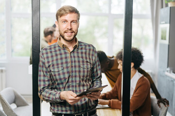 Wall Mural - business man with a digital tablet standing in the hall of the c