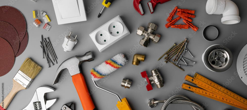 Photo Stock household hardware store items and construction tools on gray background. banner Adobe Stock