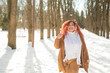 © Михаил Решетников - Cheerful fat caucasian woman walks in the park in winter.