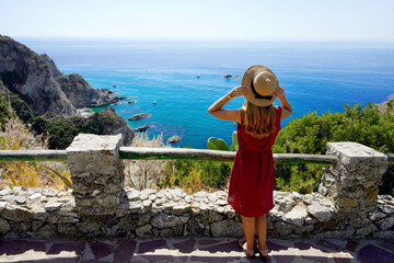 Wall Mural - Holidays in Italy. Full length of young woman with hat in Capo Vaticano on the Coast of the Gods, Calabria, Italy.