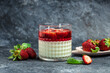 panna cotta dessert with strawberry and mint on a dark background, Long banner format. top view
