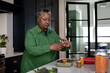 © ReeldealHD images - Senior african american female cooking a healthy meal