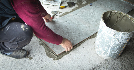 Wall Mural - Laying floor ceramic tile. Renovating the floor