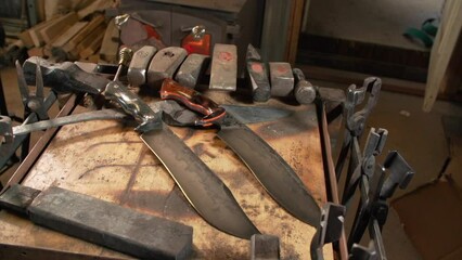 Wall Mural - Sharp knives on the wooden table in the industrial workshop