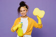 Young smiling happy housekeeper woman wear yellow shirt tidy up hold in hand bottle use spray detergent cleanser rag sponge isolated on plain pastel light purple background studio. Housework concept.