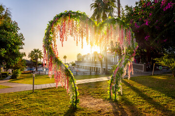 Wall Mural - Beautiful heart model at sunset with flowers