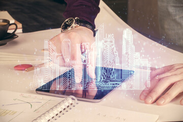 Poster - Double exposure of man's hands holding and using a digital device and city drawing.
