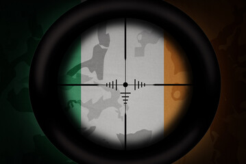 Wall Mural - sniper scope aimed at flag of ireland on the khaki texture background. military concept. 3d illustration