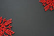 © Iuliia - New Year or Christmas background with two decorative snowflakes around the edges of a sheet of colored paper. Copy space. Bright red snowflakes on a black background.