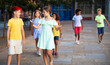 © JackF - Happy carefree tweens girl and boy enjoying friendly conversation while walking down city street during summer vacation..