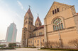 QINGDAO, SHANDONG PROVINCE, CHINA: St. Michael's Cathedral, architectural contrast with massive glass and concrete high rise