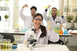 © topten22photo - The group of scientists smiled and expressed their delight at the success. in modern laboratories Mixed team of science researchers in the lab wearing white robes.