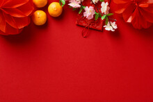 Chinese New Year 2023 Year Of The Rabbit. Red Packet Envelope, Flowers, Mandarins, Festival Decorations On Red Background. Flat Lay, Top View.