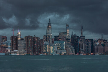 Poster - nyc cityscape with stormy cloudy blue sky in background