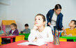 © JackF - Portrait of tired schoolgirl sitting at pupils desk at lesson in primary school