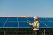 © Johnstocker - Young Asian technician man checking operation photovoltaic solar panel