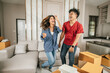 © Johnstocker - Asian Young couple have fun dancing in new home