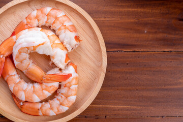 Wall Mural - Cooked shrimps on wooden background, White Prawns on a wooden Background.