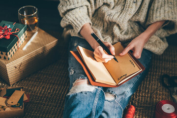 woman making to do list on 2022 year at notebook.