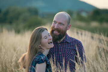 Canvas Print - Young couple in love in the summer field