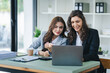 © Daenin - girl working together offer ideas to each other.happy young business colleagues working in the office