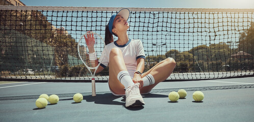 Canvas Print - Tennis, athlete and woman ready for a tennis match while sitting on the court with tennis balls. Fitness, active and young girl holding a tennis racket and ball ready for training or playing game