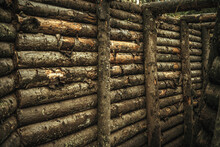 Covering The Walls Of The Trench With A Wooden Beam. A Fortification Made Of Logs.