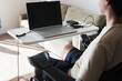 © Austockphoto - disabled man using computer, with special adaptive devices
