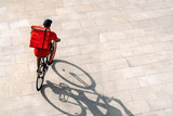 Fototapeta Zwierzęta - Delivery Man Riding Bike