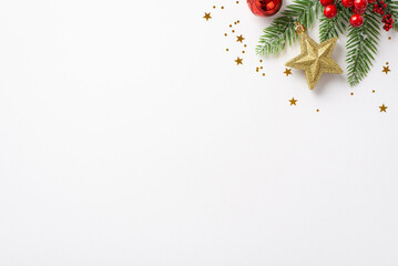 new year concept. top view photo of fir branch decorated with red bauble golden star ornament mistle