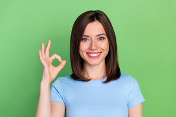 Poster - Portrait photo of young attractive lady wear blue t-shirt smiling confident business owner recommend isolated on green color background