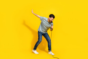 Sticker - Full length photo of talented millennial artist stylish outfit relax rest sing lovely track empty space isolated on yellow color background