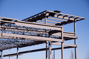 Wall Mural - Structure of steel for building construction on sky background