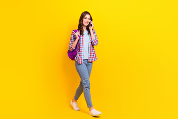 Sticker - Full body size of confident student hold smartphone talking friend online call fast connection walk from college isolated on yellow color background