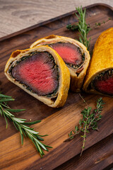 Wall Mural - Beef Wellington meat baked in dough on a wooden board.