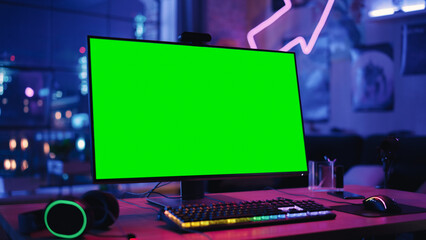 Poster - Gaming at Home: Empty Gamer Station with Player's Personal Computer with Green Screen Chroma Key Display Standing on a Wooden Desk in Stylish Loft Apartment with Neon Lights. 