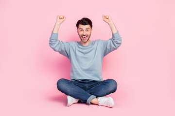 Poster - Full length photo of attractive young man lift fists support favorite sport team wear stylish blue look isolated on pink color background