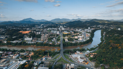 Wall Mural - 
aerial image of downtown Blumenau, with Itajaí Açú River, Santa Catarina, southern Brazil, buildings, main streets, vegetation and sunny day